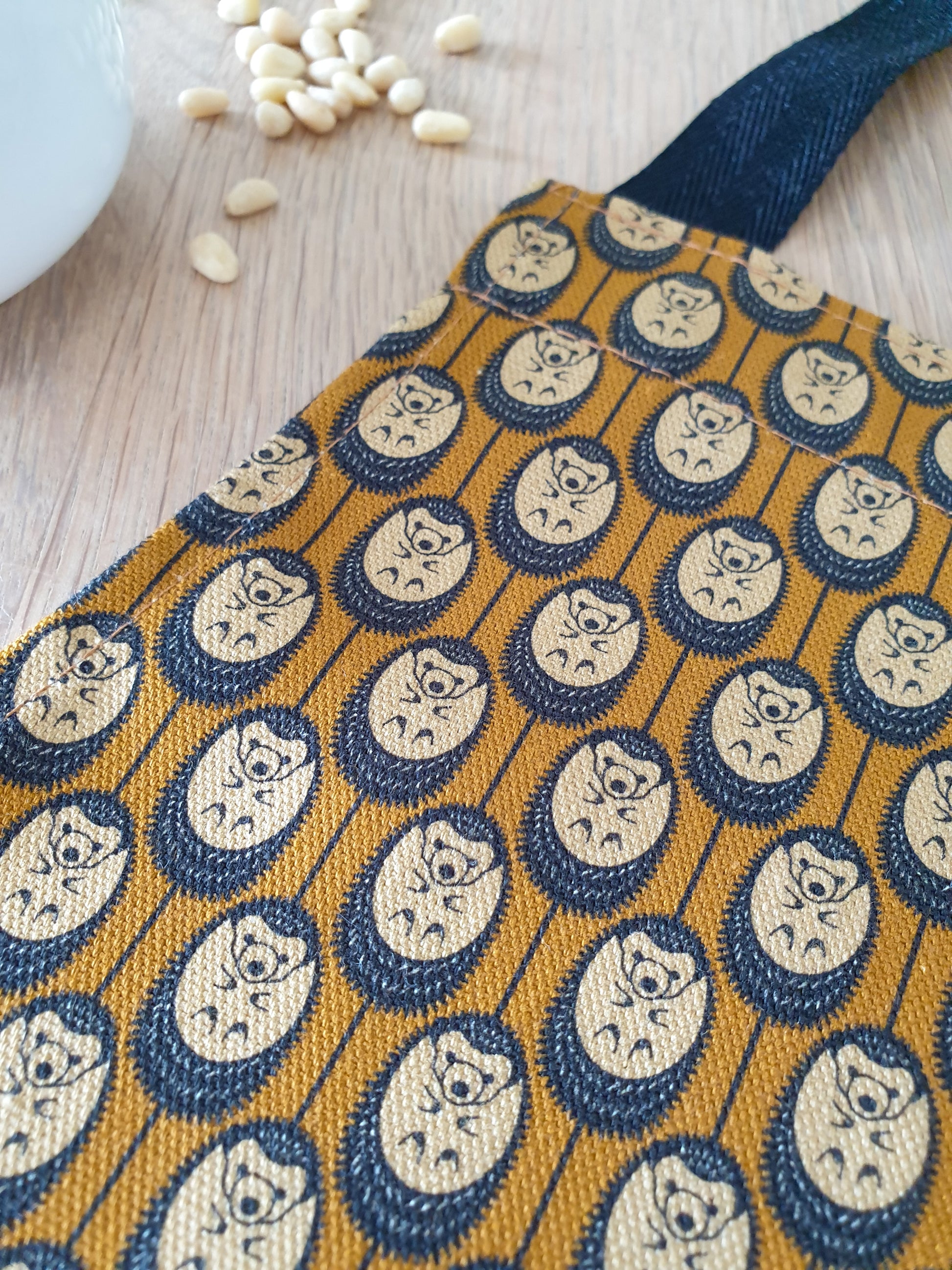 Organic cotton autumn hedgehog apron – designed by Hannah Issi and handmade in the UK. Sustainable, stylish kitchen textile close-up of print