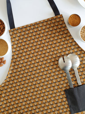 Organic cotton autumn hedgehog apron – designed by Hannah Issi and handmade in the UK. Sustainable, stylish kitchen textile pictured with cooking ingredients