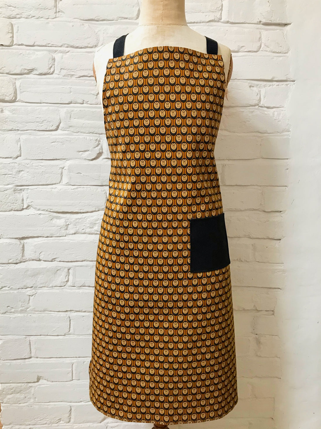 Organic cotton autumn hedgehog apron set (adult & child)– handmade in the UK by Hannah Issi. Stylish, sustainable kitchen pair- shows adult apron on a mannequin.