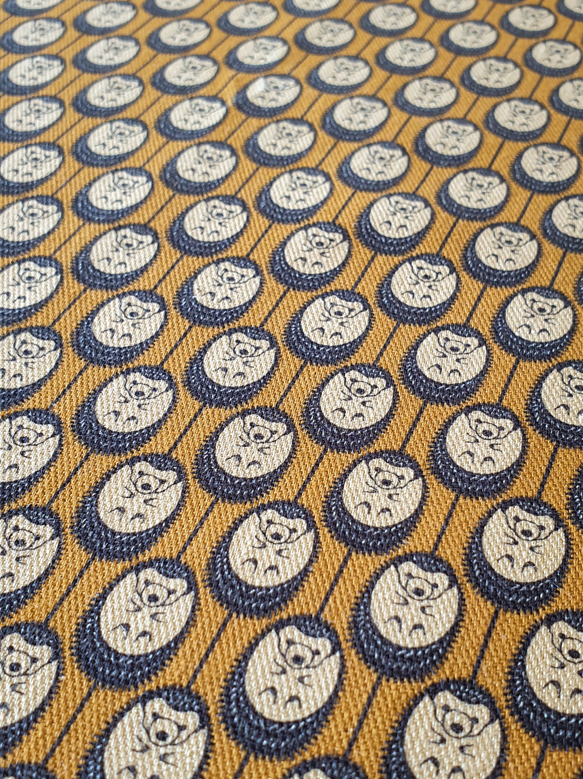 Organic cotton autumn hedgehog apron set (adult & child) – handmade in the UK by Hannah Issi. Stylish, sustainable kitchen pair - shows close-up of autumn hedgehog print.