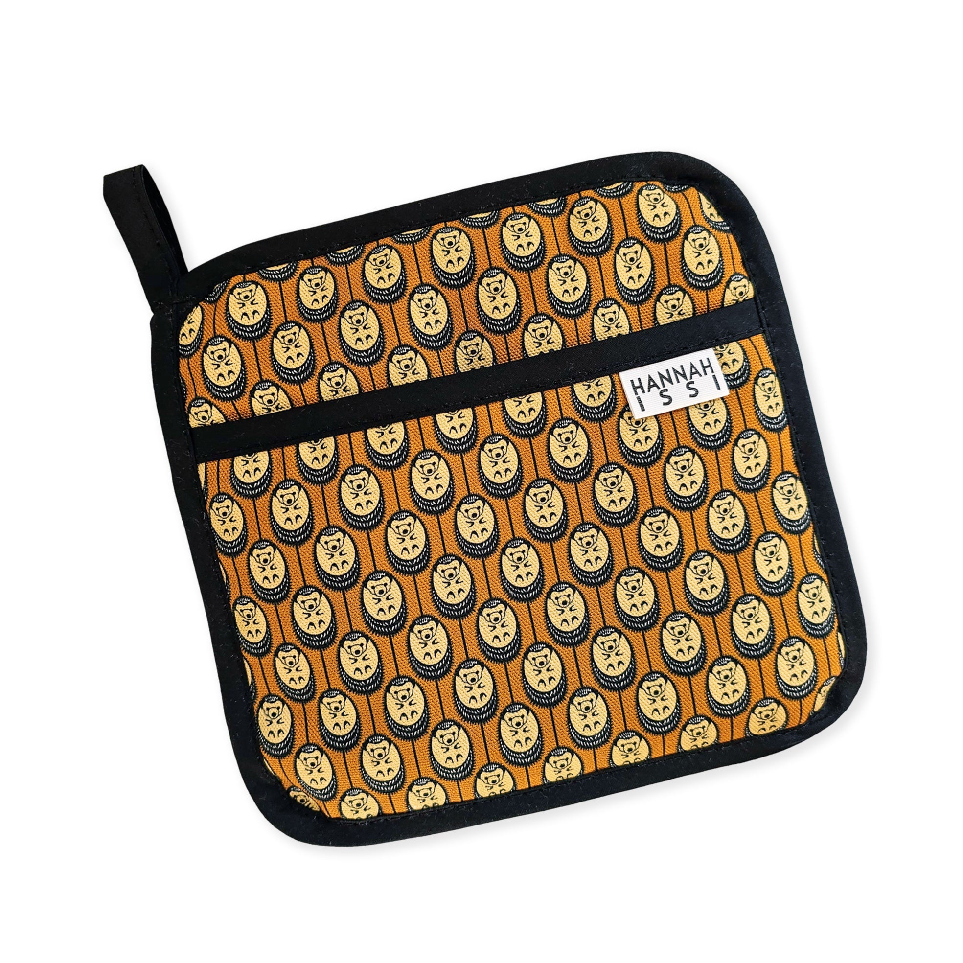 Organic cotton autumn Hedgehog pot grab – heat-safe kitchen handle cover by Hannah Issi, handmade in the UK. Stylish and functional. Cut-out image.