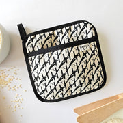 Organic cotton Black & White Magpie pot grab – heat-safe kitchen handle cover by Hannah Issi, handmade in the UK. Stylish and functional.