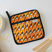 Organic cotton Orange Magpie pot grab – heat-safe kitchen handle cover by Hannah Issi, handmade in the UK. Stylish and functional.
