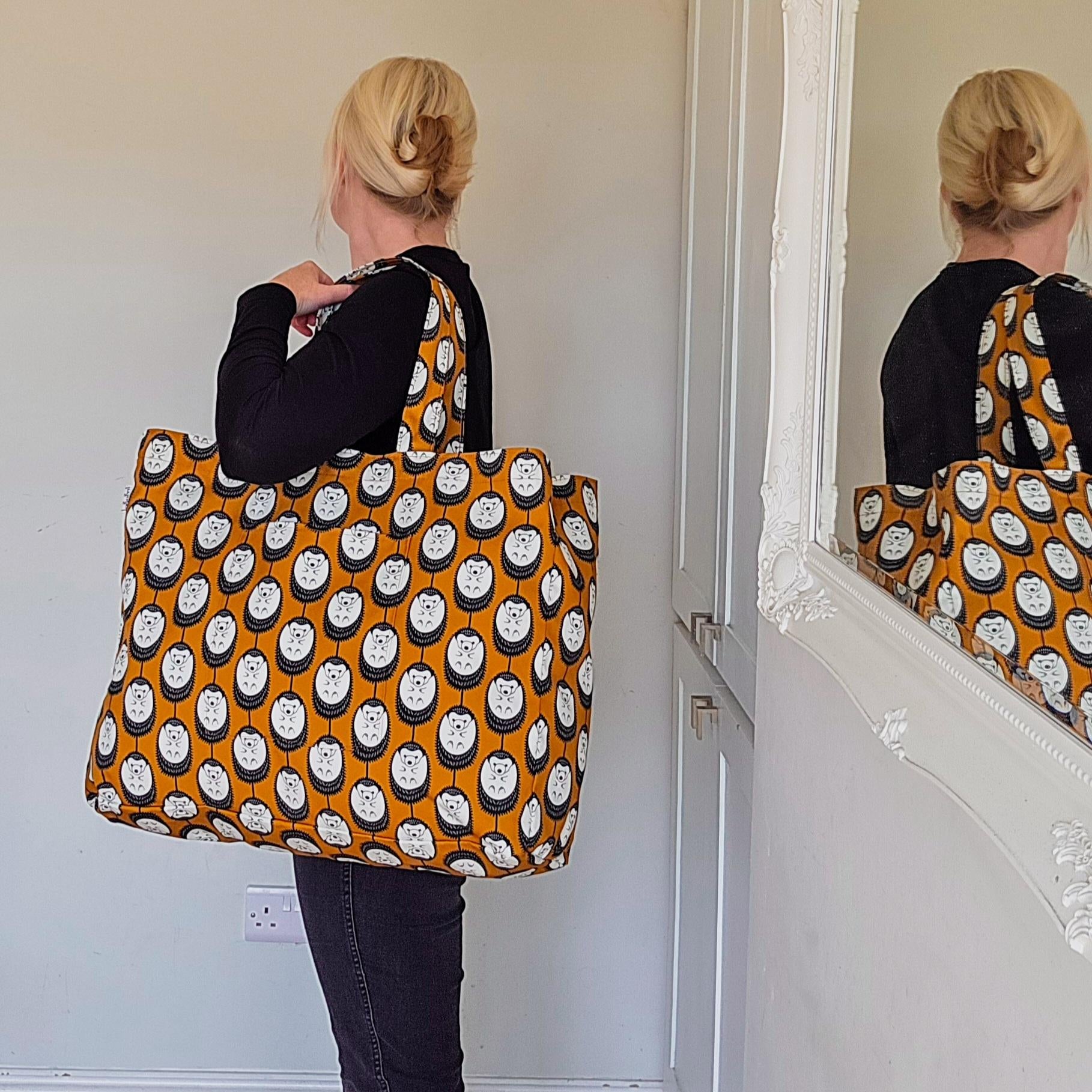 Organic cotton Brown & White Hedgehog oversized shoulder bag – large, roomy design handmade in the UK by Hannah Issi. Stylish and sustainable. Image shows bag being modelled on shoulder with mirror reflection.