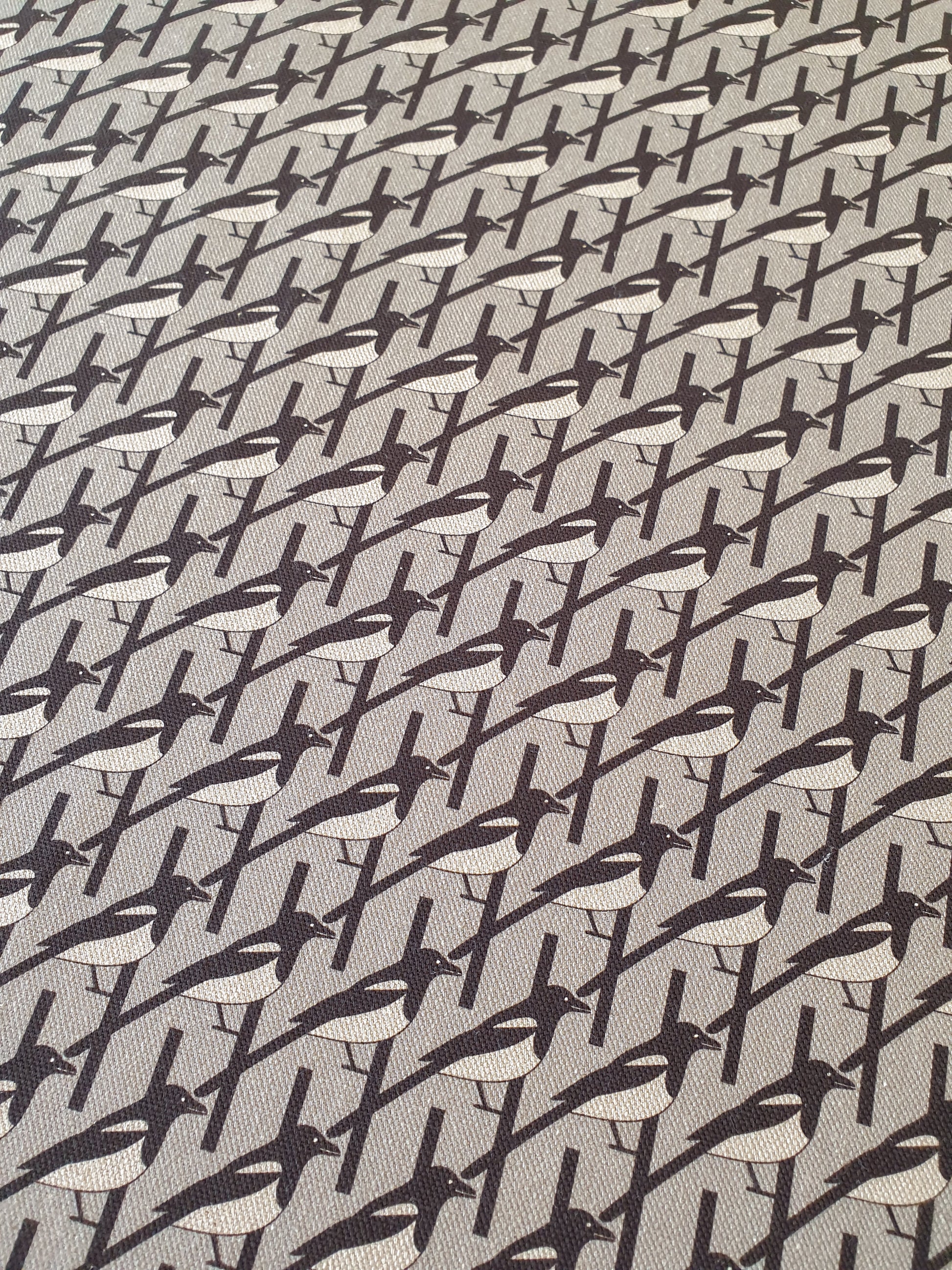 Organic cotton grey magpie tea towel – designed by Hannah Issi and handmade in the UK. Stylish, sustainable kitchen linen. Image shows close-up of pattern.